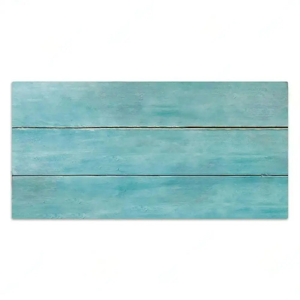 A horizontal wooden sign painted in a light blue or teal color with distressed texture.