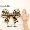 A leopard print ribbon measuring 25cm long and 30cm wide, shown next to a hand.