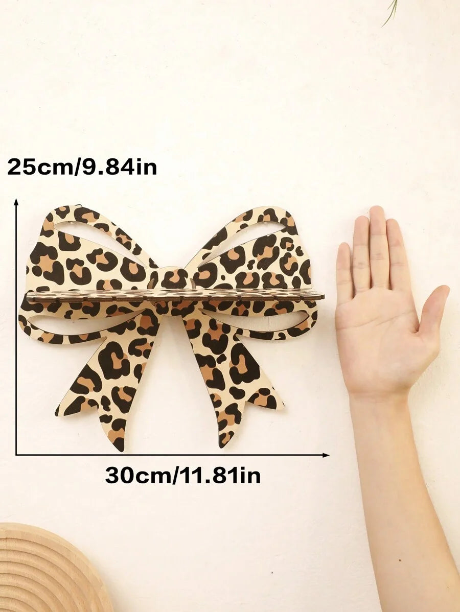 A leopard print ribbon measuring 25cm long and 30cm wide, shown next to a hand.