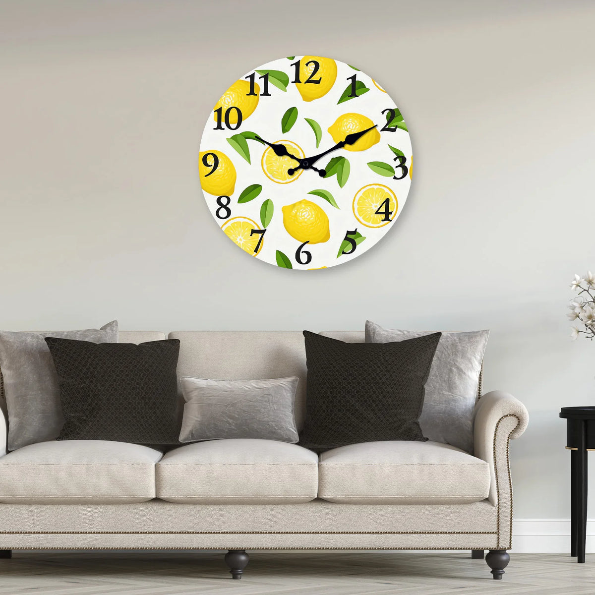 A round wall clock featuring yellow lemons and green leaves on a white background.