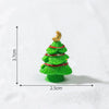 A small green resin Christmas tree charm with a gold star topper, shown against a white background.