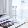 Elegant clear glass pillar candle holder with a textured design shown on a white surface.