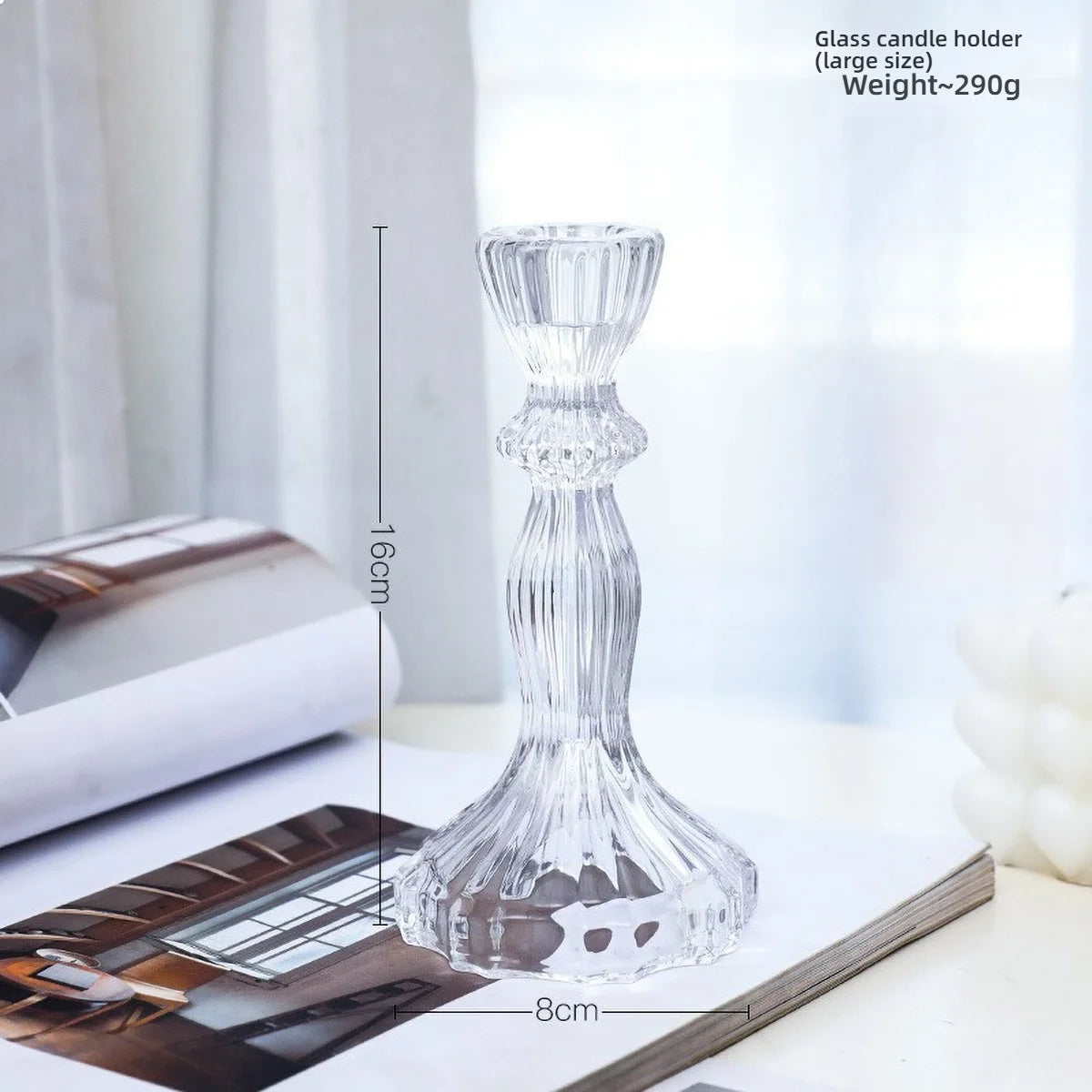 Elegant clear glass pillar candle holder with a textured design shown on a white surface.