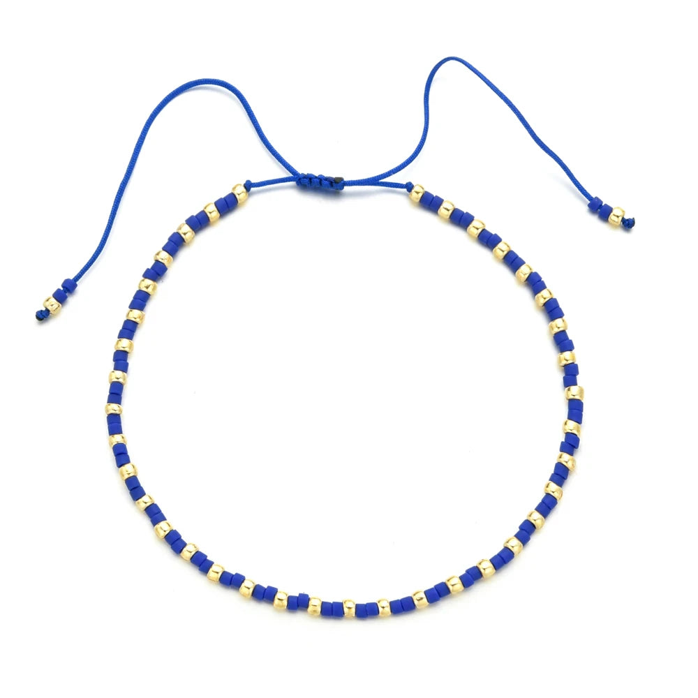 Handmade boho glass bead bracelet with adjustable cord in blue and gold beads