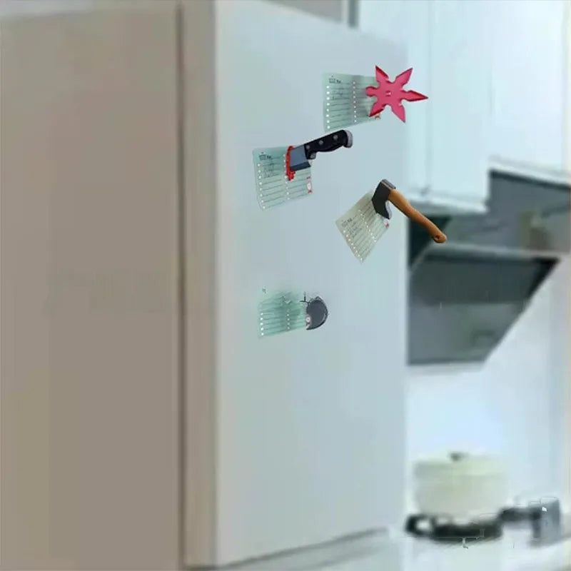 A white fridge magnet featuring a 3D axe design with a pink star decoration.