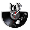 A black vinyl record shaped wall clock featuring silhouettes of musicians playing instruments and the text I Jazz