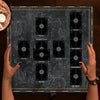 Hands holding a Celtic Cross Altar Cloth for Tarot & Divination spread on a dark surface.