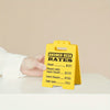 A yellow desk sign listing sarcastic answer desk rates for $1.00 to $4.00 and free dumb looks.