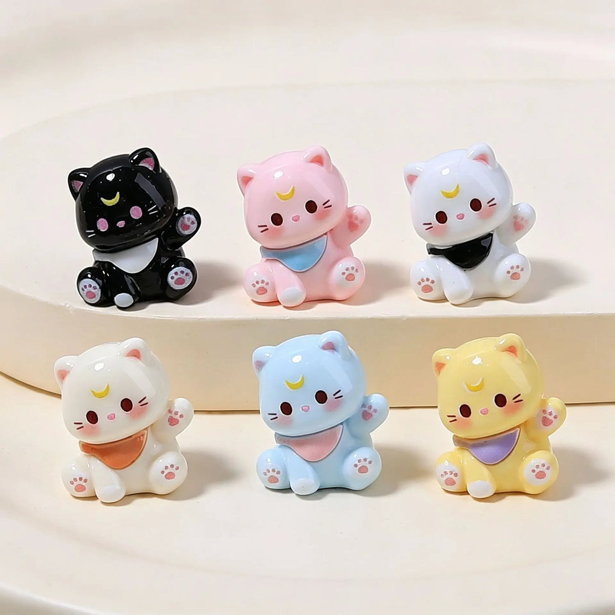 A collection of five pink and white kawaii 3D resin cat animal keychains displayed on a light background.