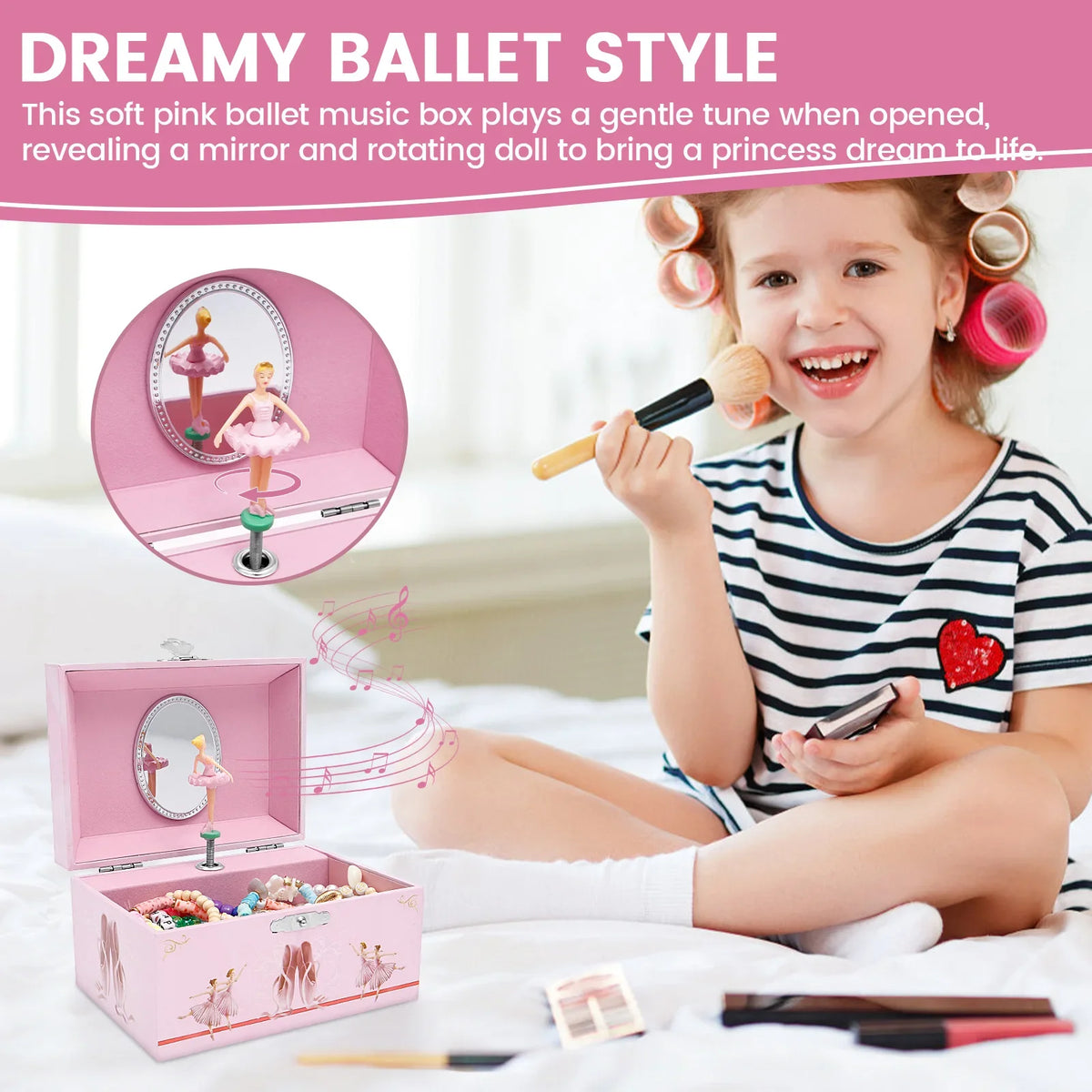 A young girl is playing a pink ballet music box that opens to reveal a mirror and a rotating doll.
