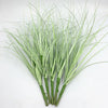 A bundle of artificial grass greenery with slender, light green blades and thick stems.