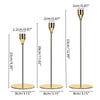 Set of three metal taper candle holders with varying heights and a gold finish.