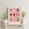 Framed canvas art featuring watercolor illustrations of various fruits like apples and citrus slices on pink paper