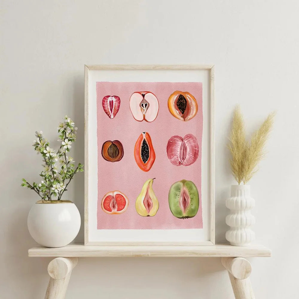 Framed canvas art featuring watercolor illustrations of various fruits like apples and citrus slices on pink paper