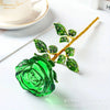 A vibrant green crystal glass rose flower branch decoration on a white surface.