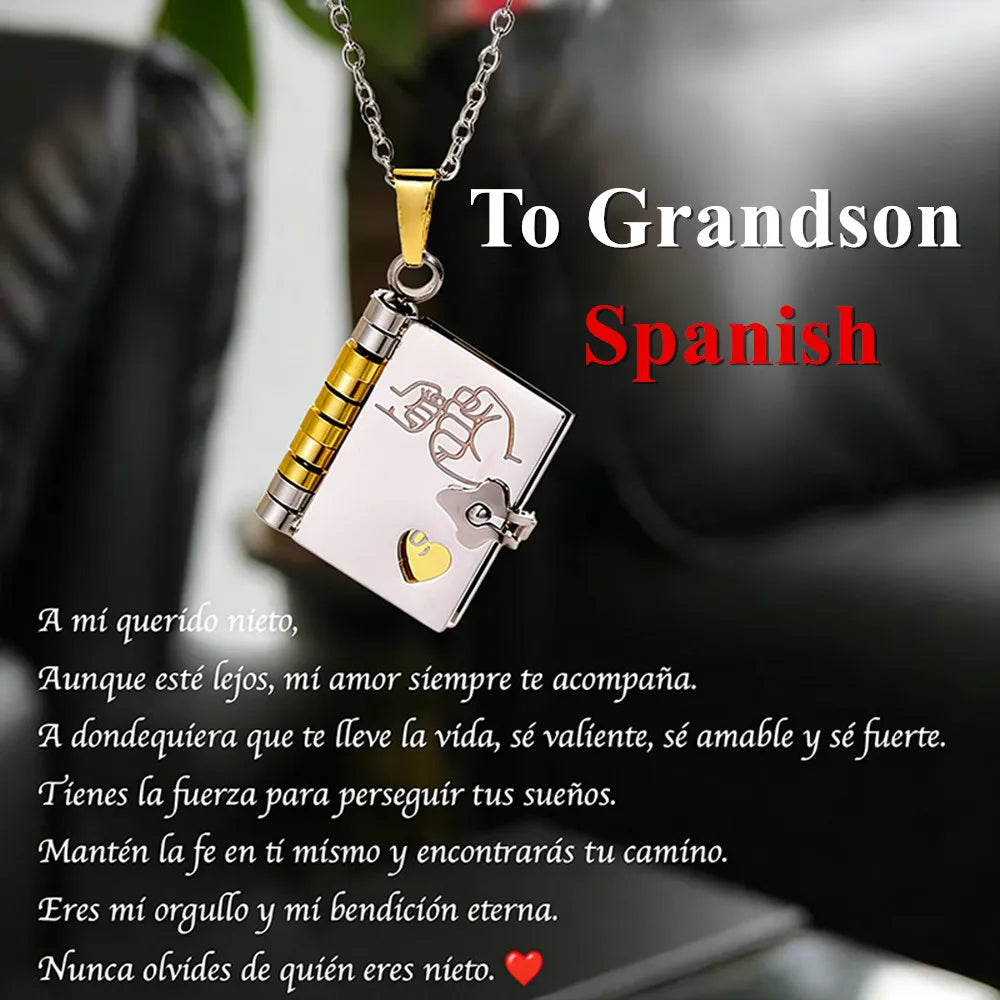 A silver pendant necklace featuring an openable book design with an engraved message and a heart charm.