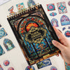 A hand holds a sheet of vintage floral window scrapbooking stickers featuring colorful stained glass designs.