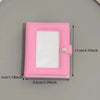A pink mini photo card binder with a clear plastic cover and a snap closure.