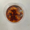 A challenge coin featuring a fierce, fiery depiction of a mythical creature or figure.