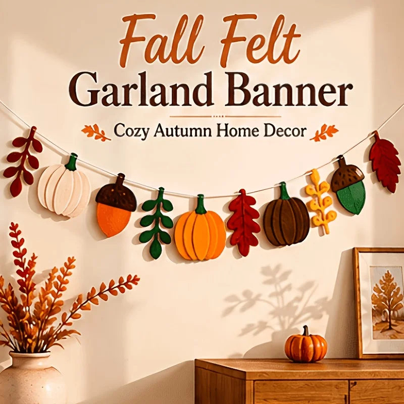 A felt garland banner featuring autumn harvest decorations including pumpkins, acorns, and maple leaves displayed on a wall.