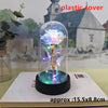 An LED galaxy rose artificial flower displayed inside a glass dome on a black base.