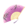 A pink and yellow vintage bamboo folding fan decorated with floral accents.