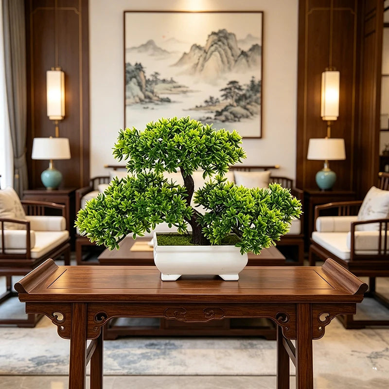 A potted artificial bonsai tree decoration sits on a dark wooden table in a traditional interior setting.