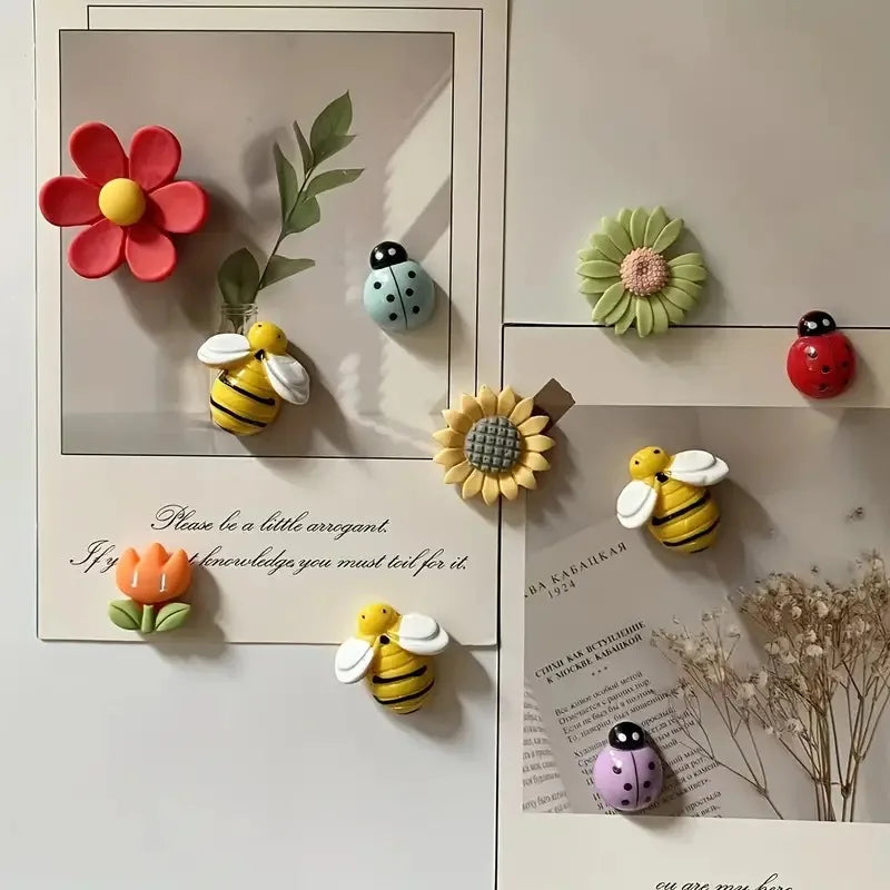 A set of reusable fridge magnets featuring flowers, bees, and other natural elements on a white background.