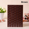 A brown PVC photo corner protector with a geometric pattern is displayed next to white flowers.