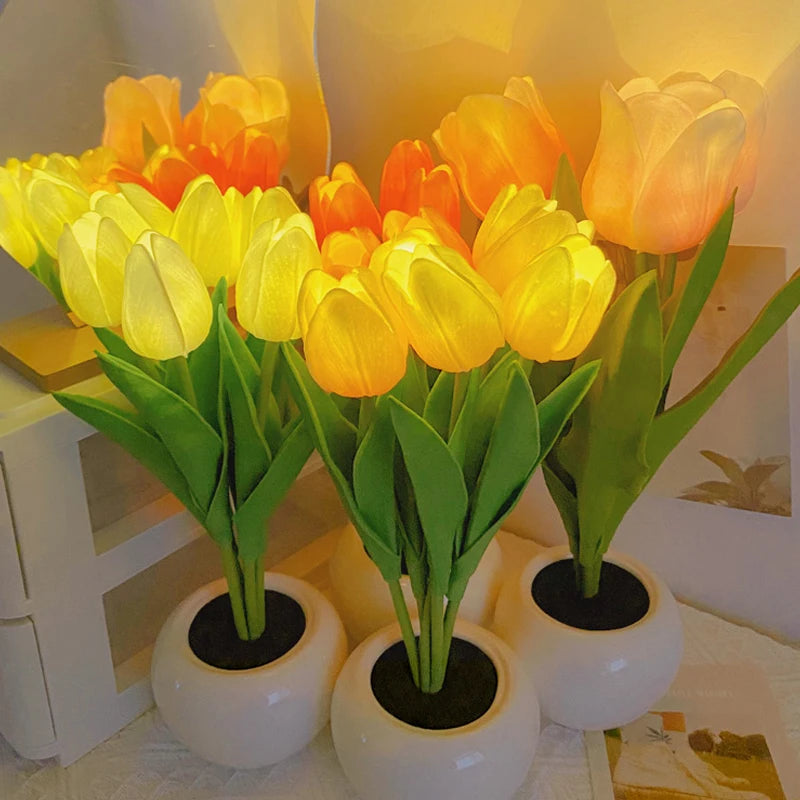 A bouquet of yellow and orange tulips in white ceramic pots used as a night light.