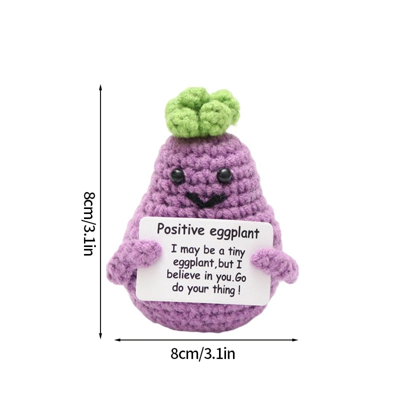 Handmade crochet positive eggplant doll with a small pocket containing an inspirational message
