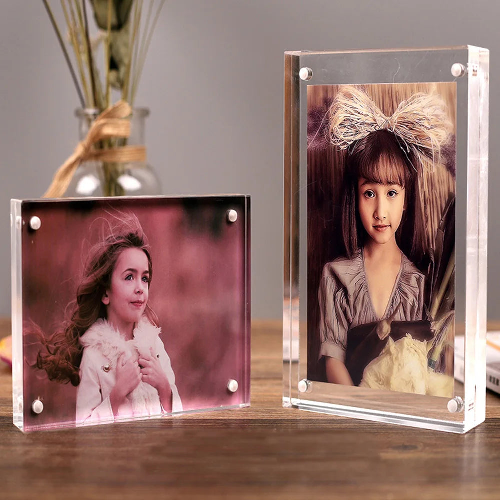 A clear acrylic magnetic photo frame displaying a portrait of a girl with her hair tied in a bow.