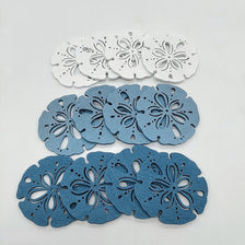 A collection of twelve wooden ocean ornaments featuring various sea life shapes like shells, scallops, and starfish.