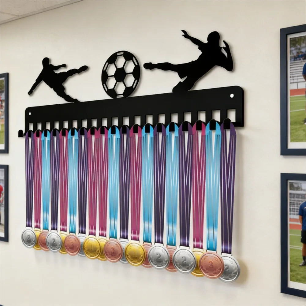 A black metal medal display rack with 20 hooks for wall mounting is mounted on a white wall.