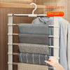 A white multi-layer pants hanger with stainless steel rods is shown holding folded gray and blue pants.