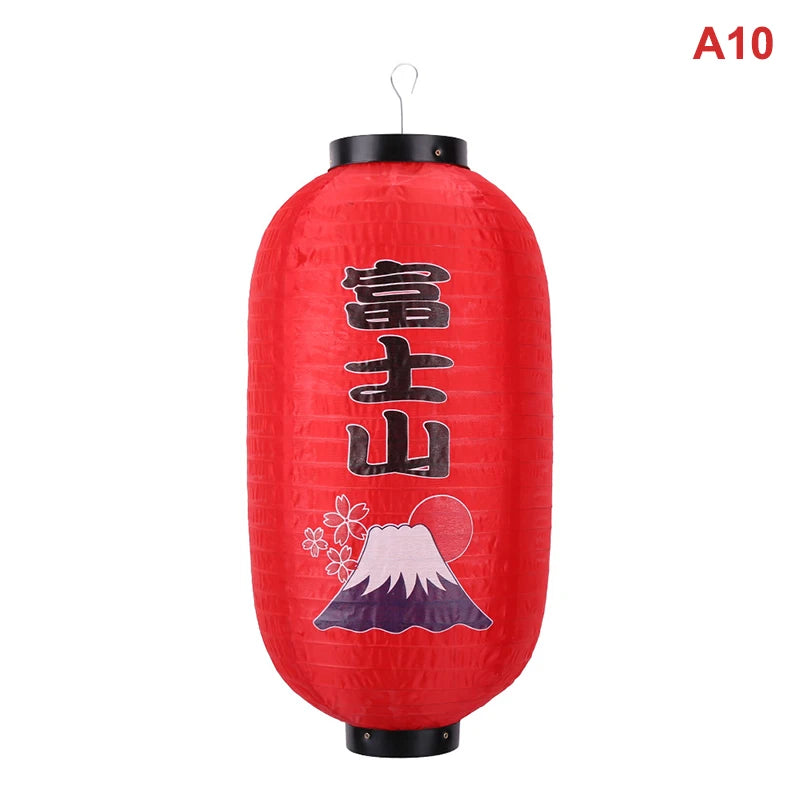 A red paper hanging lantern featuring Mount Fuji and a rising sun design.