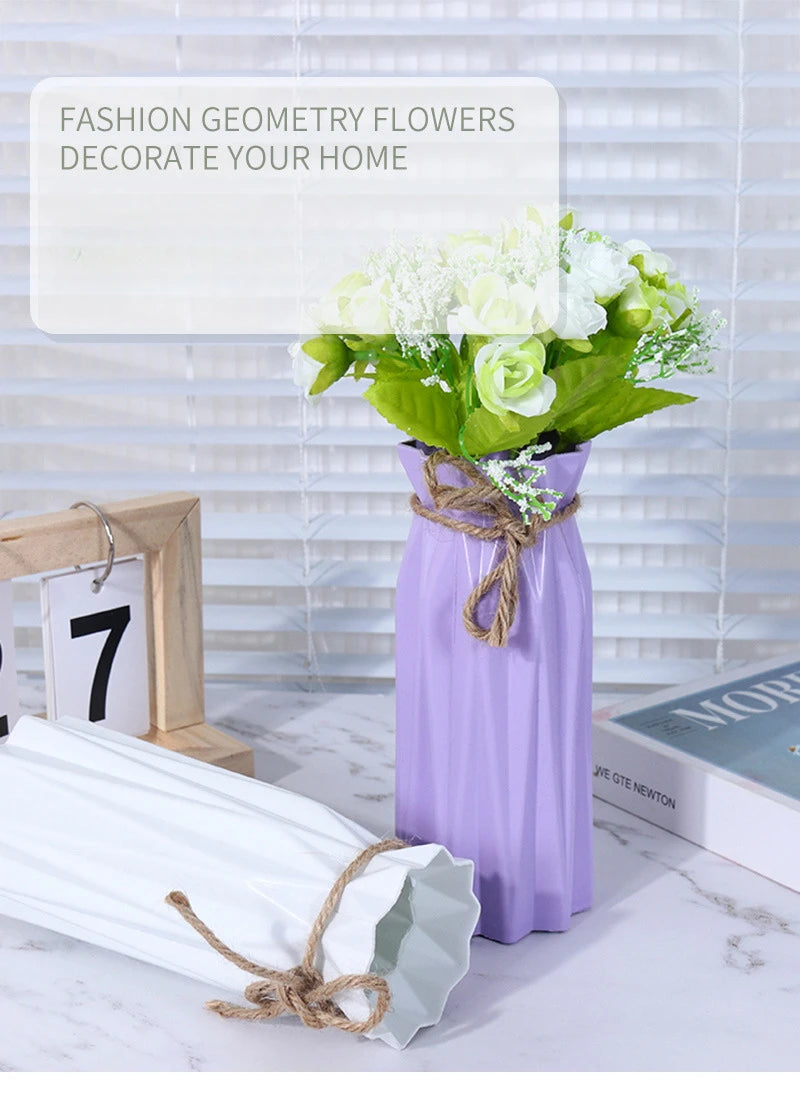 A purple plastic vase holds a bouquet of white flowers, decorated with twine, on a white marble surface.