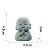 A small, round stone statue of a meditating monk with hands clasped, measuring 4.2cm high.