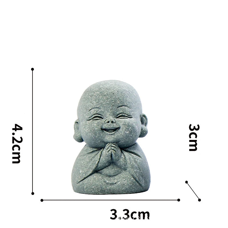 A small, round stone statue of a meditating monk with hands clasped, measuring 4.2cm high.