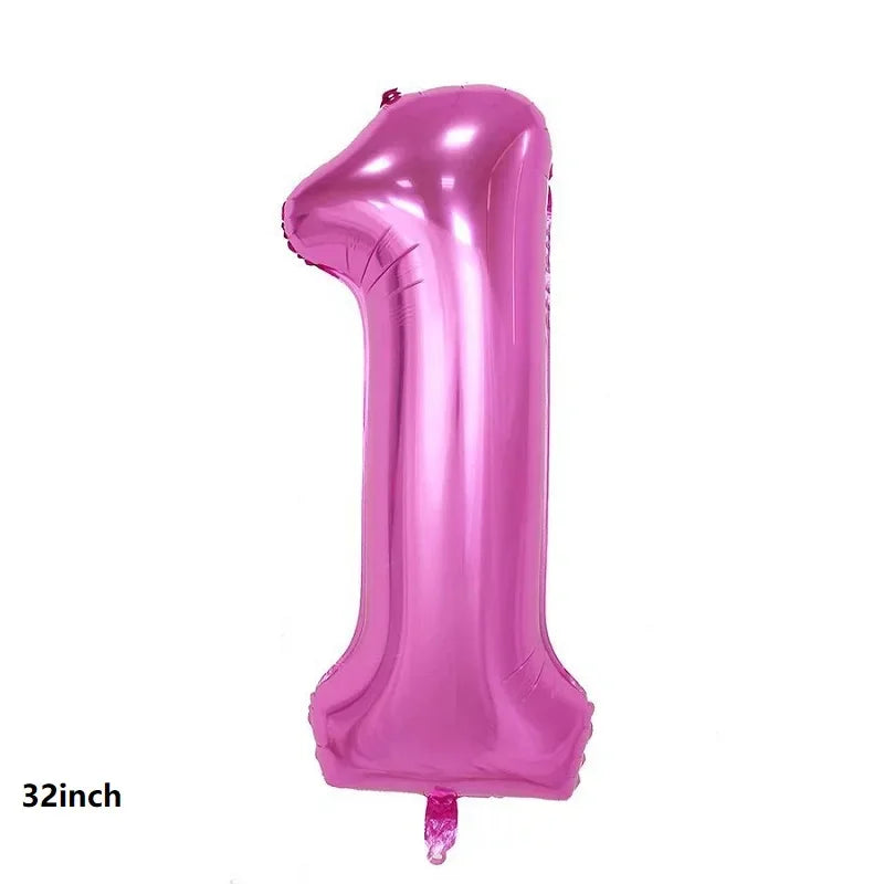 A single, shiny pink latex balloon shaped like the number one.