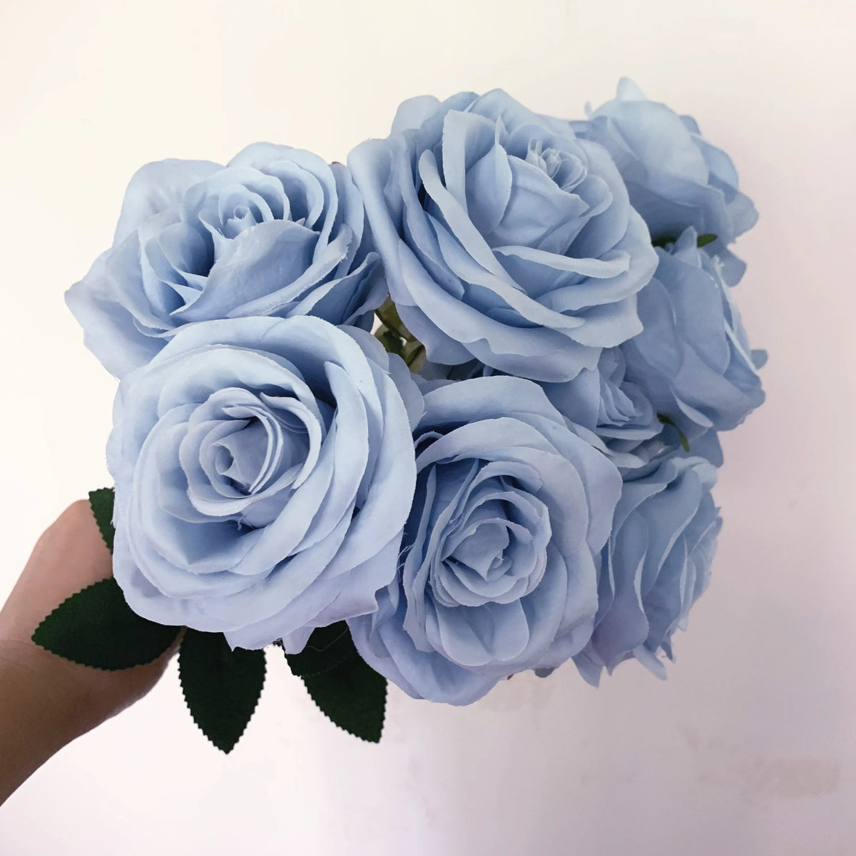 A bouquet of light blue silk roses for home and wedding decor.