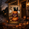 A decorative Halloween display featuring a black cat and white ghosts on a wooden sign surrounded by pumpkins and autumn foli