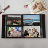 A black linen cover photo album displaying various family and landscape photographs.