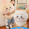 A soft white Usagi Chiikawa plush doll is shown next to a white bear plush doll, displayed in a bright, cheerful setting.