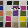 A grid of various colored fabric swatches and samples for an eggplant product line.