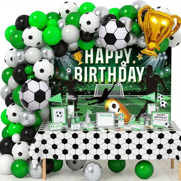 A festive balloon arch display featuring soccer balls, balloons in green and white, and a golden trophy for a birthday party.