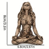 A bronze-colored statue of a female figure with long flowing hair in a meditative pose.