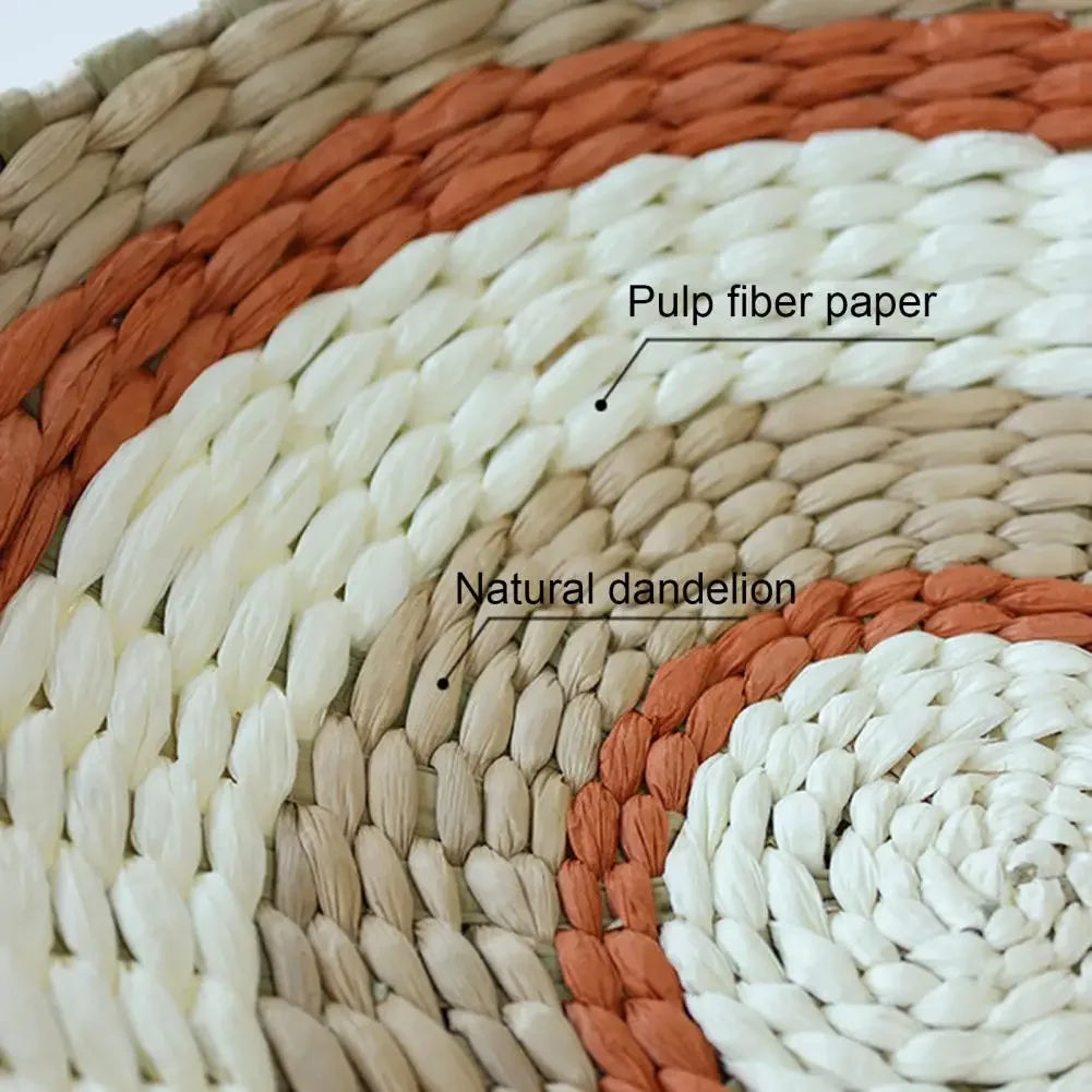 Close-up of natural dandelion fiber paper woven into a bohemian straw wall decor hanging with shades of white and terracotta.