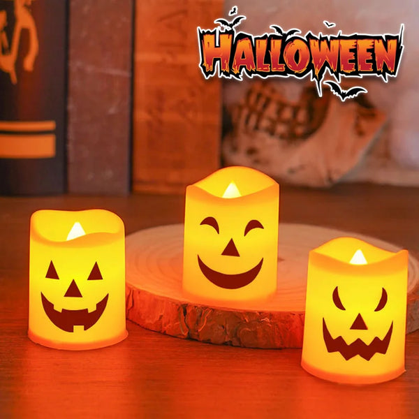 A set of glowing orange flameless LED candles shaped like jack-o'-lanterns and skulls for Halloween decor.