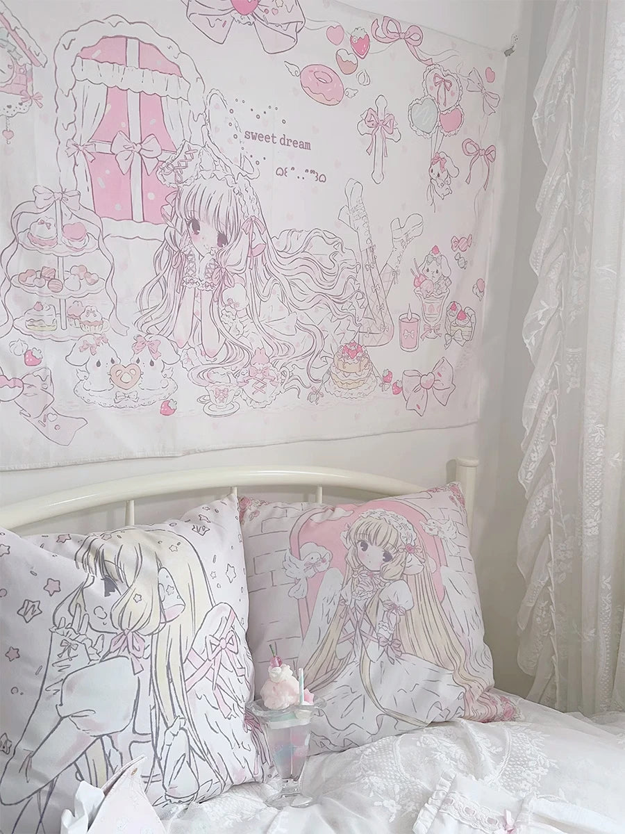 A white wall tapestry featuring a sweet dream theme with pink and white cartoon characters and flowers above a bed.